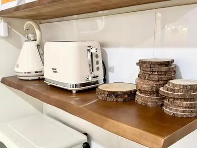 a kitchen counter with a toaster and stacks of coins at The Little Bali - 6Room - 18Pax in Kuala Lumpur