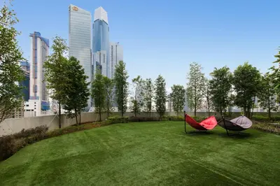 two hammocks sitting on a lawn in a city at Agile Bukit Bintang by Avery at KLCC#5 mins to Pavilion &TRX#Garden Pool#Free Parking#中英文房东 in Kuala Lumpur