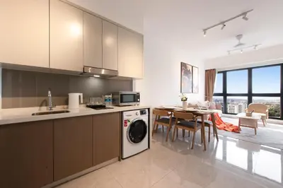 a kitchen with a washing machine and a dining room at Agile Bukit Bintang by Avery at KLCC#5 mins to Pavilion &TRX#Garden Pool#Free Parking#中英文房东 in Kuala Lumpur