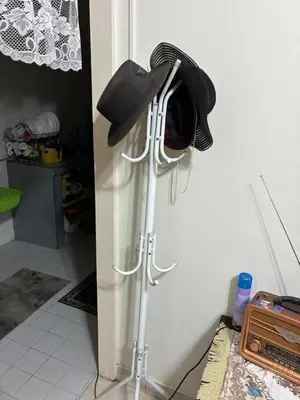 a hat hanging on a wall next to a door at Baiduri Homestay in Kuala Lumpur
