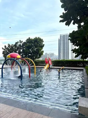 a pool with two water slides in the water at M Vertica Homestay in Kuala Lumpur