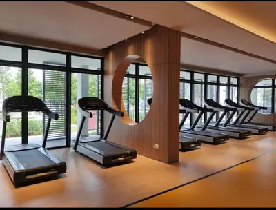 a row of exercise bikes in a gym with windows at M Vertica Homestay in Kuala Lumpur