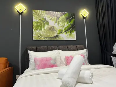 a bedroom with two lamps and a bed with pink pillows at The Majestic Gen Luxury Suites KLCC in Kuala Lumpur