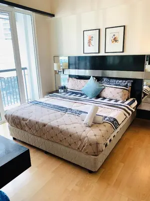 a large bed in a bedroom with a large window at Anhome Seri bukit Ceylon in Kuala Lumpur