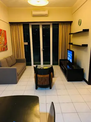 a living room with a couch and a tv at Anhome Seri bukit Ceylon in Kuala Lumpur