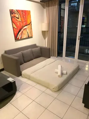 a living room with a couch with a teddy bear on it at Anhome Seri bukit Ceylon in Kuala Lumpur