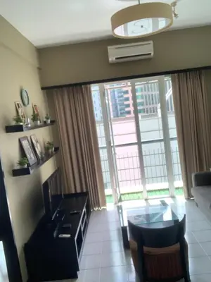 a living room with a table and a large window at Anhome Seri bukit Ceylon in Kuala Lumpur