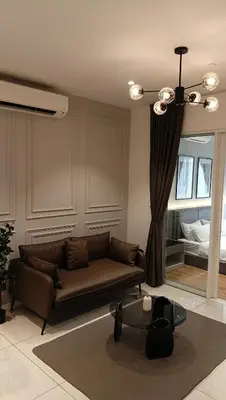 a living room with a couch and a bed at Quill Residence - Blissful Urban Condo by Azmila in Kuala Lumpur