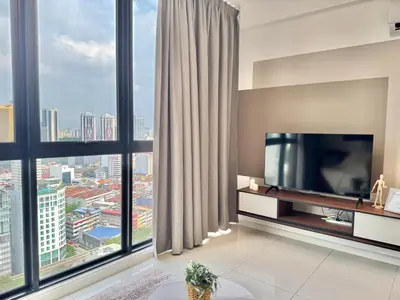 a living room with a television and large windows at Majestic Residence Suite KLCC in Kuala Lumpur