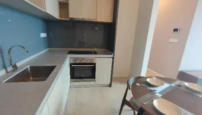 a kitchen with a sink and a stove top oven at Bedin Hotels in Kuala Lumpur
