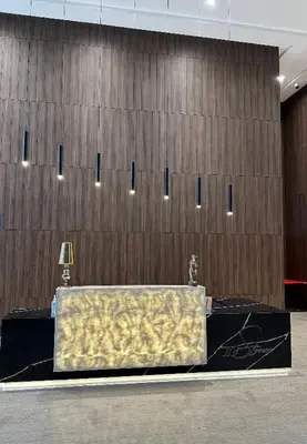 a table in front of a wooden wall at Bedin Hotels in Kuala Lumpur
