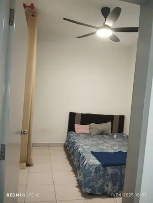 a bedroom with a bed and a ceiling fan at Flora Residency Setapak in Kuala Lumpur