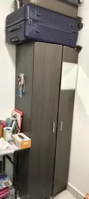 a gray cabinet with a suitcase on top of it at Flora Residency Setapak in Kuala Lumpur