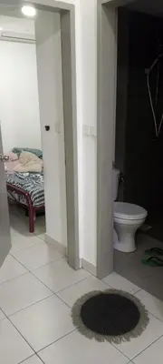 a bathroom with a toilet and a bed in a room at Flora Residency Setapak in Kuala Lumpur