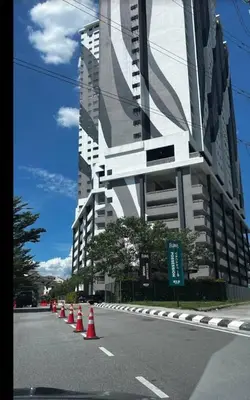 a street with orange cones in front of a tall building at Flora Residency Setapak in Kuala Lumpur
