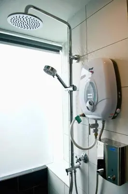a shower in a bathroom with a light on the wall at I LUX I-Hotel Kuala Lumpur in Kuala Lumpur