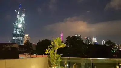 a city skyline at night with a tall building at I LUX I-Hotel Kuala Lumpur in Kuala Lumpur