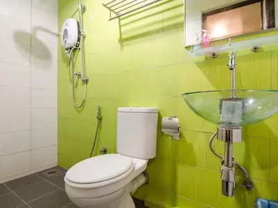 a bathroom with a toilet and a glass sink at I LUX I-Hotel Kuala Lumpur in Kuala Lumpur