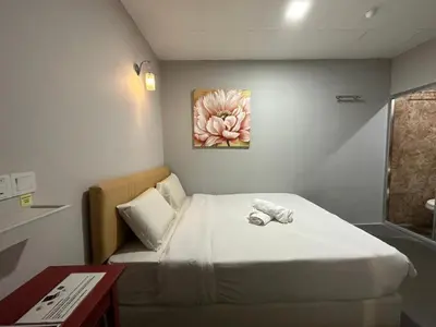 a small room with a bed and a couch at Triple B Hotel in Kuala Lumpur