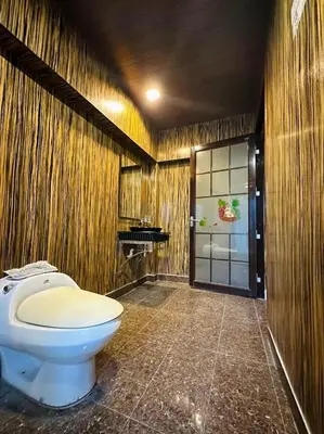 a bathroom with a toilet and a sink at Triple B Hotel in Kuala Lumpur