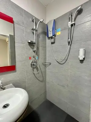 a bathroom with a shower and a white sink at Triple B Hotel in Kuala Lumpur