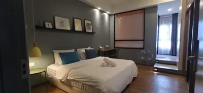 a bedroom with a large white bed and a window at Penthouse-Bukit Bintang in Kuala Lumpur