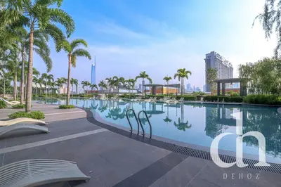 an image of a swimming pool with palm trees at Trion KL Residence by Dehoz Suites in Kuala Lumpur