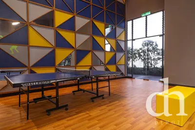 a ping pong table in a room with a colorful wall at Trion KL Residence by Dehoz Suites in Kuala Lumpur