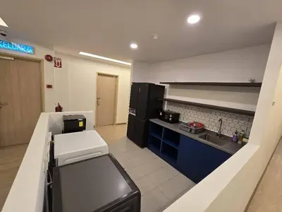 a kitchen with a sink and a counter top at The Backpackers Hut Chow Kit in Kuala Lumpur
