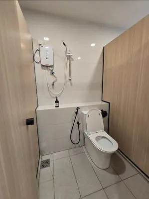 a bathroom with a toilet and a shower at The Backpackers Hut Chow Kit in Kuala Lumpur
