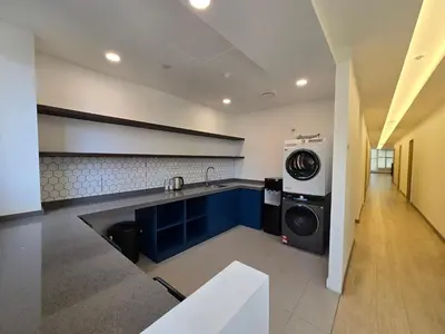 a kitchen with a sink and a washing machine at The Backpackers Hut Chow Kit in Kuala Lumpur