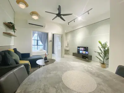 a living room with a table and a ceiling fan at Arte Mont Kiara By Comfortcorner in Kuala Lumpur