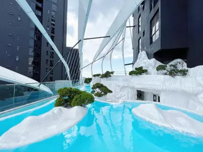 a swimming pool with icebergs and plants in a city at Arte Mont Kiara By Comfortcorner in Kuala Lumpur