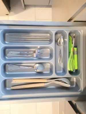 a plastic container with utensils in a refrigerator at Eaton Residence KLCC Kuala Lumpur in Kuala Lumpur