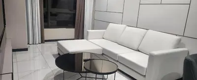 a living room with a white couch and a table at Luxury Suites at Wyndham KLCC in Kuala Lumpur