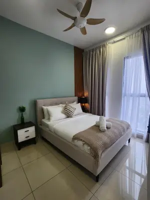 a bedroom with a bed and a ceiling fan at Luxury Suites at Wyndham KLCC in Kuala Lumpur