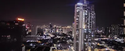 a tall building in a city at night at Luxury Suites at Wyndham KLCC in Kuala Lumpur