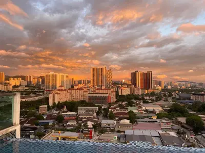 a view of a city at sunset with buildings at The nest apartment in Kuala Lumpur