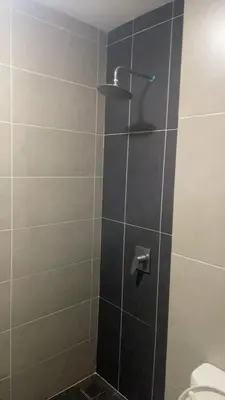 a shower with a glass door with a toilet at The nest apartment in Kuala Lumpur