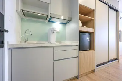 a kitchen with a sink and a tv at Riveria City Home Plus in Kuala Lumpur