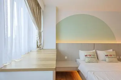 a bedroom with a bed and a large window at Riveria City Home Plus in Kuala Lumpur