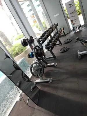 a row of exercise equipment in a gym at Vortex Suites KLCC by Comfy Stay in Kuala Lumpur