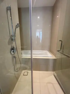 a bathroom with a shower and a bath tub at Pavilion Ceylon Hill Luxury suit Bukit Bintang by cupidhome in Kuala Lumpur