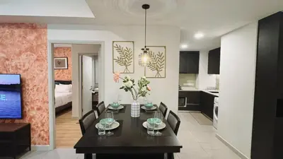 a dining room and kitchen with a table and chairs at The Atrium at Jalan Ampang by OKBnB- Modern Cozy 3 Bedroom Apartment 4 Mins to KLCC in Kuala Lumpur