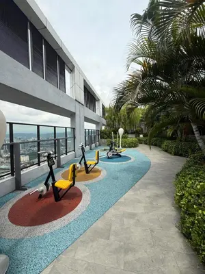 a building with figurines of people playingogie boards on a sidewalk at Trion KL Residence By CozyNest in Kuala Lumpur