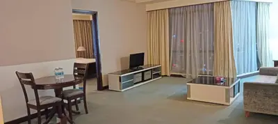 a living room with a table and a living room with a couch at Times Square apartment klcc in Kuala Lumpur