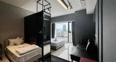 a black room with a bed and a window at Bukit Bintang in Kuala Lumpur