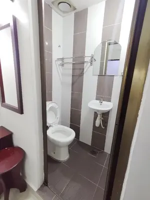 a bathroom with a toilet and a sink at J Hotel Masjid India KL in Kuala Lumpur