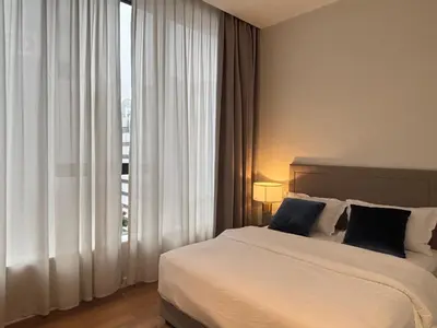 a bedroom with a bed and a large window at Pavilion Ceylon Hill Luxury apartment Bukit Bintang by cupidhome in Kuala Lumpur