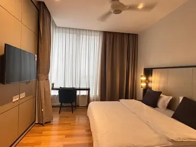 a hotel room with a bed and a television at Pavilion Ceylon Hill Luxury apartment Bukit Bintang by cupidhome in Kuala Lumpur